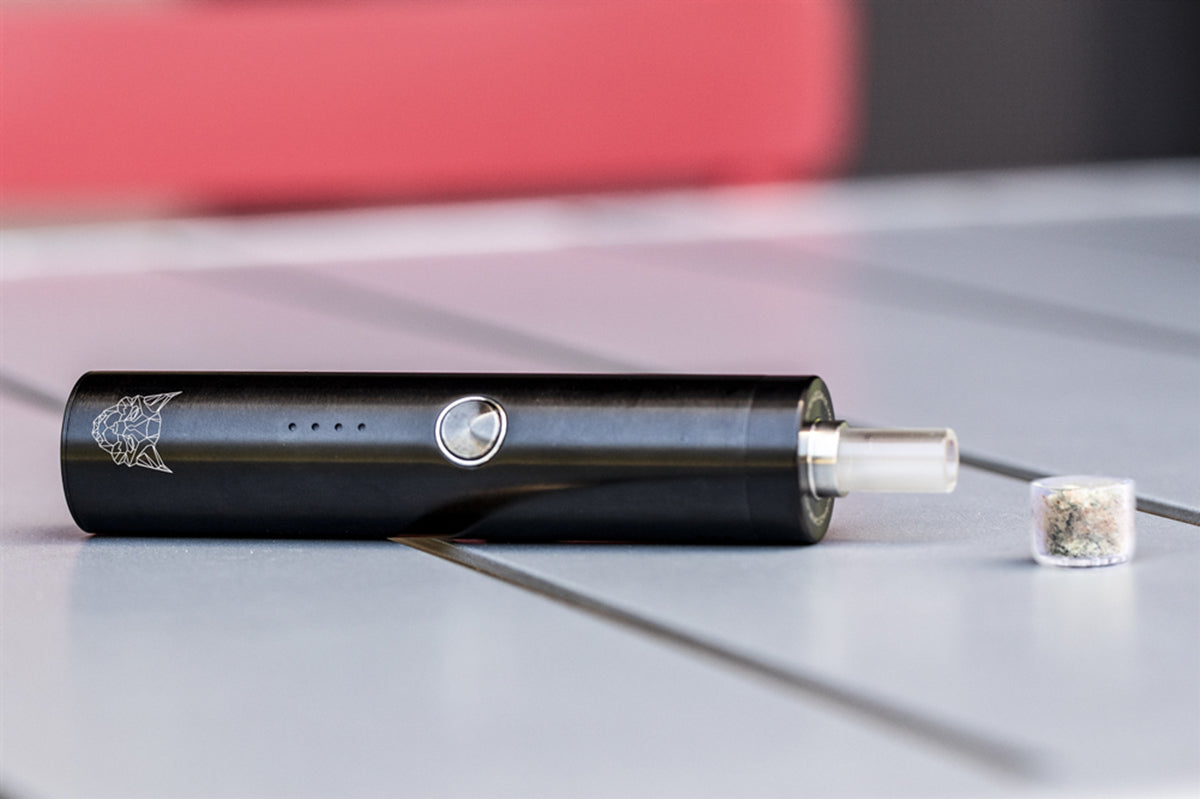 Dry herb cannabis flower on desk with smoking accessories