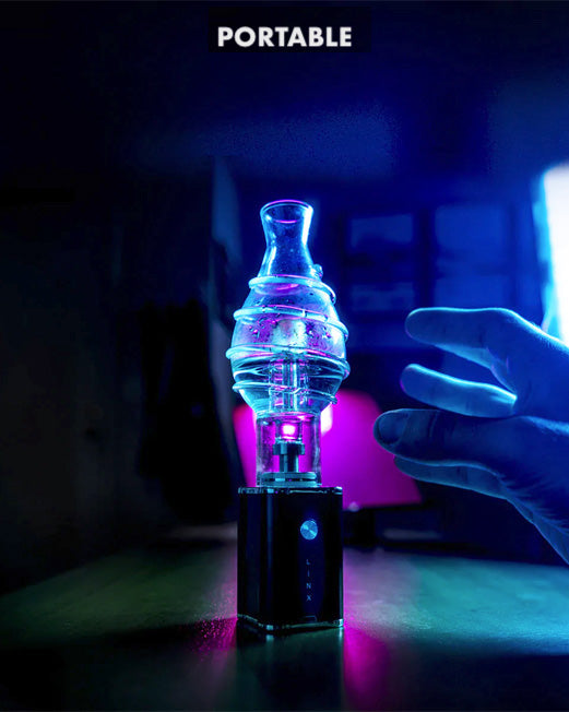 Linx Apoll Electric Dab Rig and E Nail in Portable Dab Rig mode with Linx Bubbler on Dark Background with purple light, with a hand reaching into frame