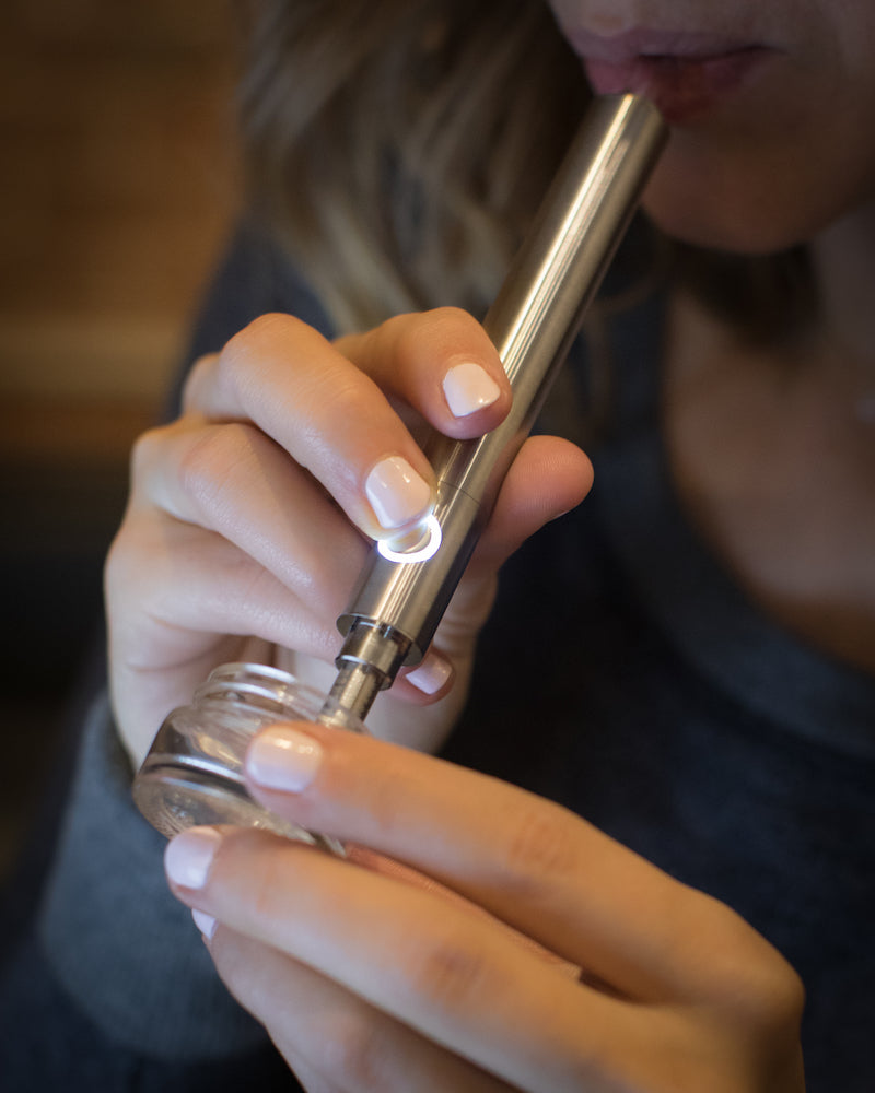 Linx Ares Honey Straw Dab Pen Being Dipped Into Extract Container By a Woman